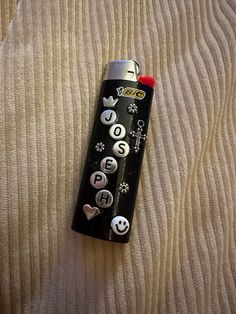 a black remote control sitting on top of a bed