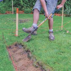 a man digging in the ground with a shovel