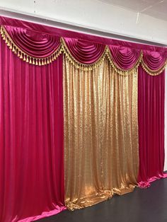 an empty room with pink and gold curtains