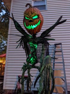 an outdoor halloween decoration in front of a house