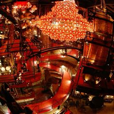 a large chandelier hanging from the ceiling in a room filled with red lights