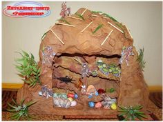 this is an image of a rock house made out of rocks and stones with decorations on it