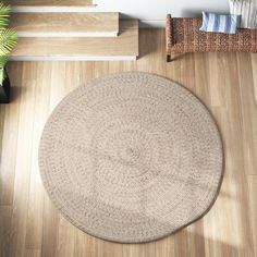 a round rug on the floor next to stairs