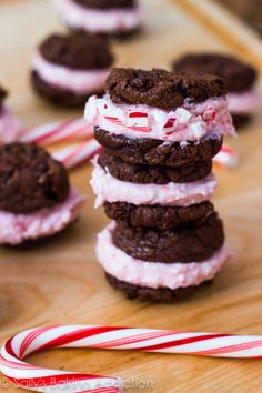 cookies and marshmallows are stacked on top of each other with candy canes