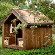 a small wooden shed with logs in the outside and wood on the inside for storage