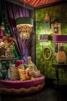 a living room filled with lots of furniture next to a wall covered in green and purple curtains