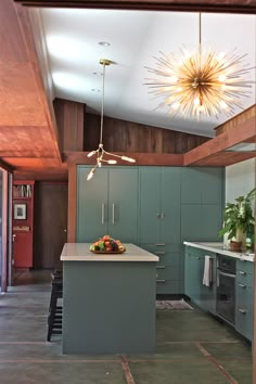 a kitchen with green cabinets and an island