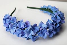 a blue flower crown on a white table