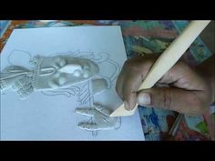 someone is drawing a skeleton on paper with a pencil and some paintbrushes in their hands