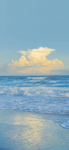 two people walking on the beach with surfboards