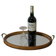 a bottle of wine sitting on top of a wooden tray