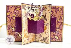 an open card with purple and gold flowers on it, the front is folded up