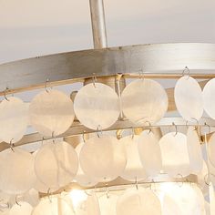 a chandelier with white glass discs hanging from it