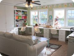 a living room filled with furniture and lots of windows next to a white kitchen island