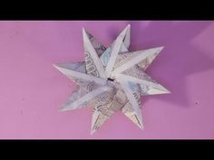 an origami star made out of money on a pink background with the words, how do you make it?