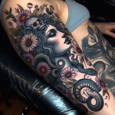 a woman's arm with flowers and a snake on it