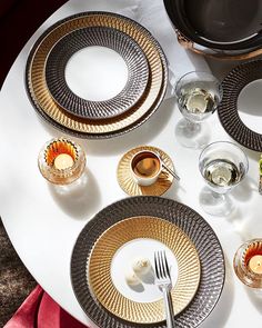 a white table topped with plates and silverware