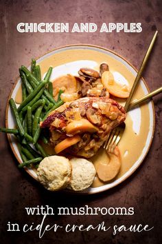 chicken and apples with mushrooms in cider cream sauce on a plate next to cauliflower