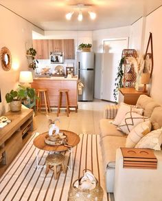 a living room filled with furniture and a flat screen tv sitting on top of a wooden table