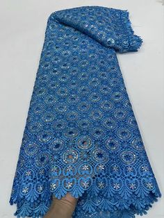 a blue shawl with an intricate design on it