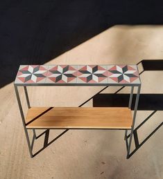 a table with two benches on it and one bench is made out of concrete tiles