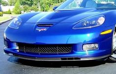 a blue sports car is parked on the street