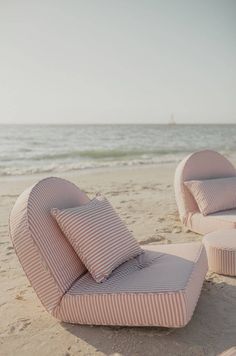 an outdoor lounge chair and ottoman on the beach