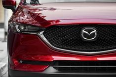 the front end of a red mazda car