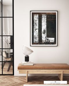 a modern living room with a large painting on the wall and a wooden bench in front of it