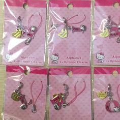 six hello kitty cell phone charms in pink packaging