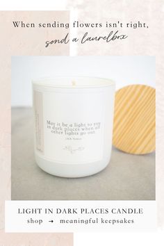 a candle with the words, light in dark places candle shop on it and an image of