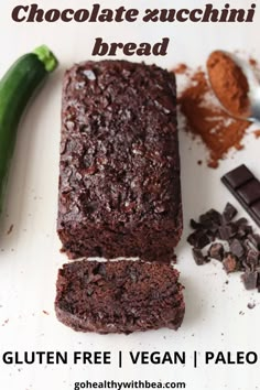 two pieces of chocolate cake sitting on top of a white cutting board next to a green pepper