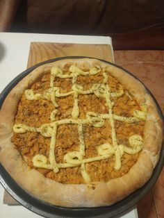 a pizza sitting on top of a pan covered in toppings