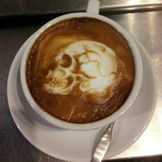 a cup of coffee with a skull drawn in it