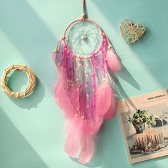 a pink dream catcher sitting on top of a blue table