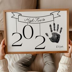 a person holding up a sign that says high five to 1202 with their handprint