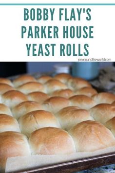 a close up of a loaf of bread on a pan with the words bobby flay's parker house yeast rolls