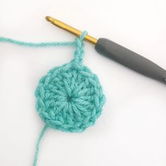 the crochet is being worked on with a knitting needle