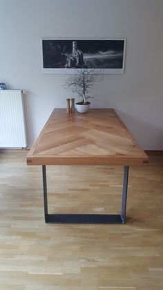 a wooden table sitting on top of a hard wood floor