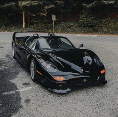 a black sports car is parked in the parking lot