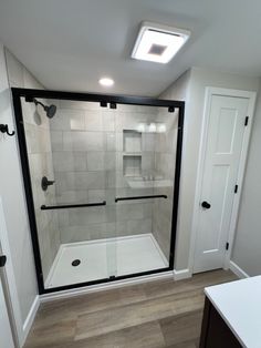 a walk in shower sitting inside of a bathroom