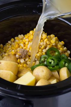 corn, potatoes and green peppers are being poured into the slow cooker