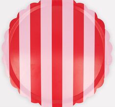 a red and white striped paper plate with scalloped edges