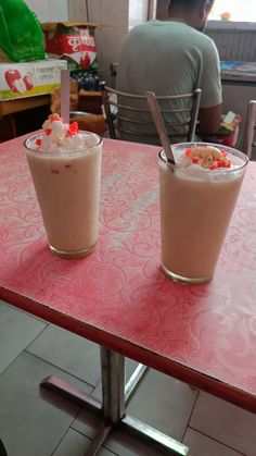 two drinks sitting on top of a red table