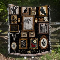 a blanket with many pictures on it hanging in front of a fence and some trees