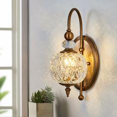 a wall light with a glass ball on it