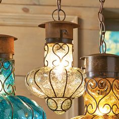 three colorful glass lamps hanging from chains