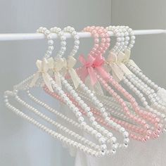 several white and pink hair ties hanging on a rack