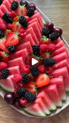 watermelon slices and blackberries arranged on a platter