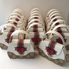 many boxes with bows and ribbons are stacked on top of each other in a row